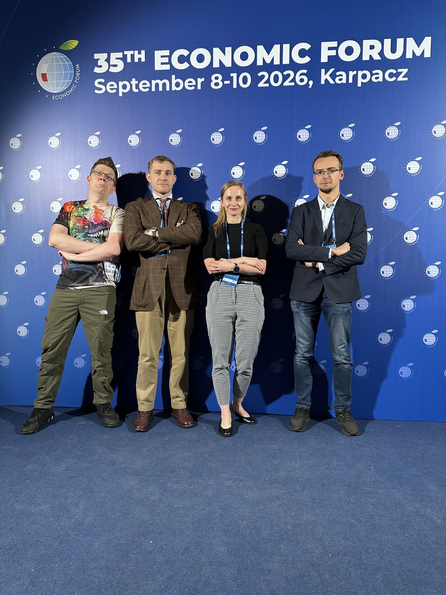 CCAI researchers standing in front of the 35th Economic Forum photo wall